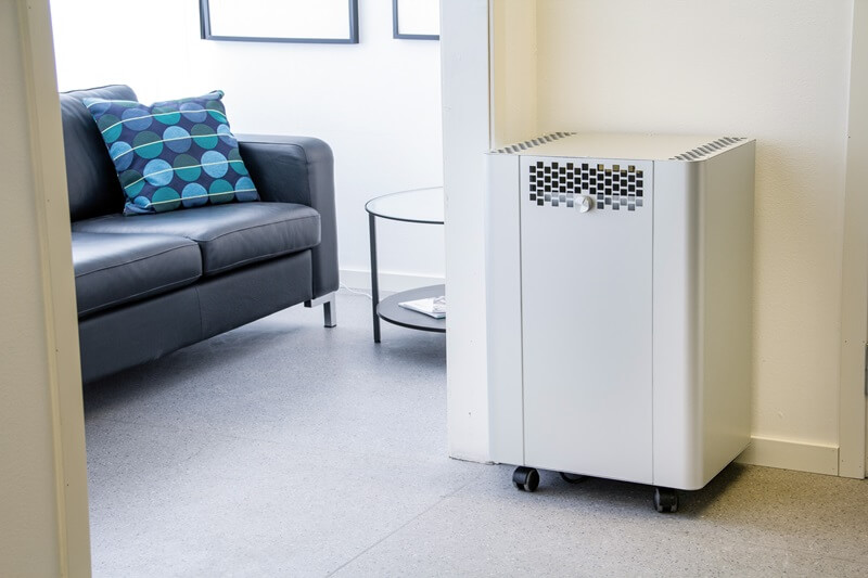 An Acetec APU 500 air cleaner installed in a meeting room in an office.